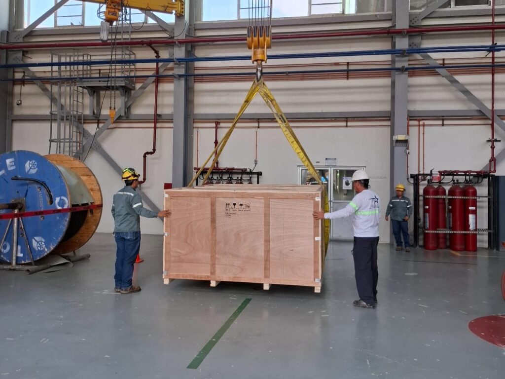 Maniobra de izaje de equipo HVAC para instalación de sistema de climatización industrial.